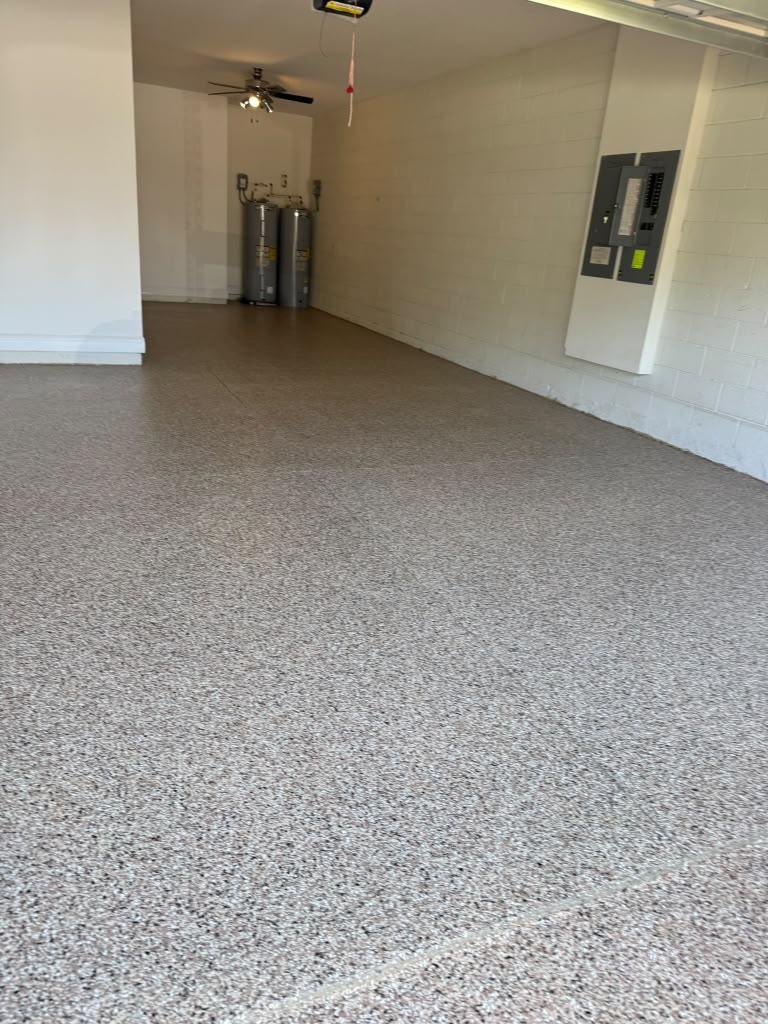Residential garage with a tan and grey flake epoxy floor
