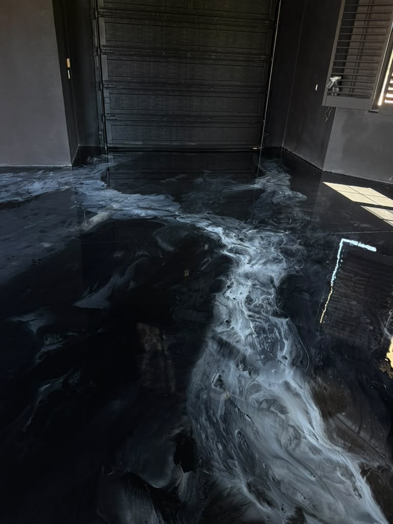 High-gloss black and silver metallic epoxy floor in a garage